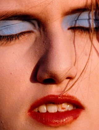 Image from All I Want to Be by Thomas de Kluyver showing model in smudged blue eyeshadow and messy red lipstick