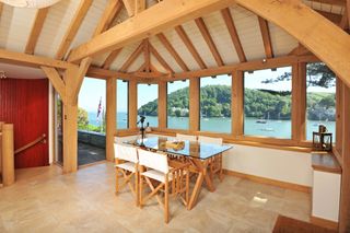 boathouse with dining terrace having wooden beams