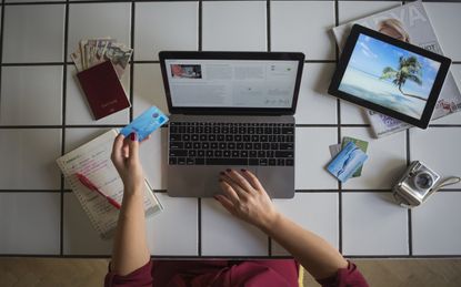 A person books travel with a credit card on the internet.