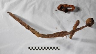A partially bent sword with rust