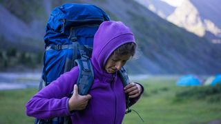 what is a mid layer: hiker wearing a fleece jacket