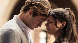 James and Ruby standing with their foreheads touching.