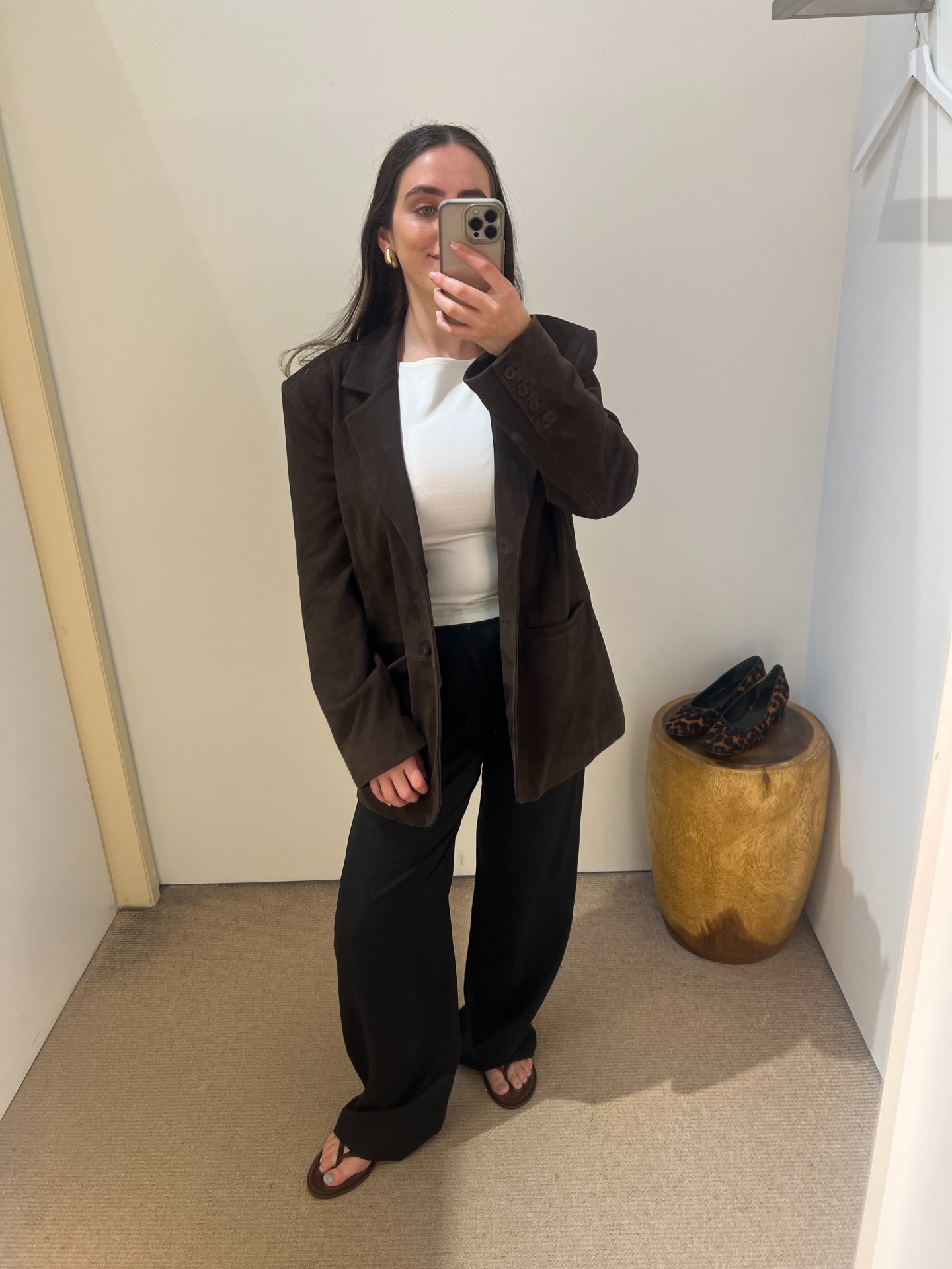 An image of Ava Gilchrist wearing Reformation&#039;s Mason Pants, Dusk Knit Top, Leon Oversized Suede Blazer and Jessie Thong Sandal in Espresso Suede.