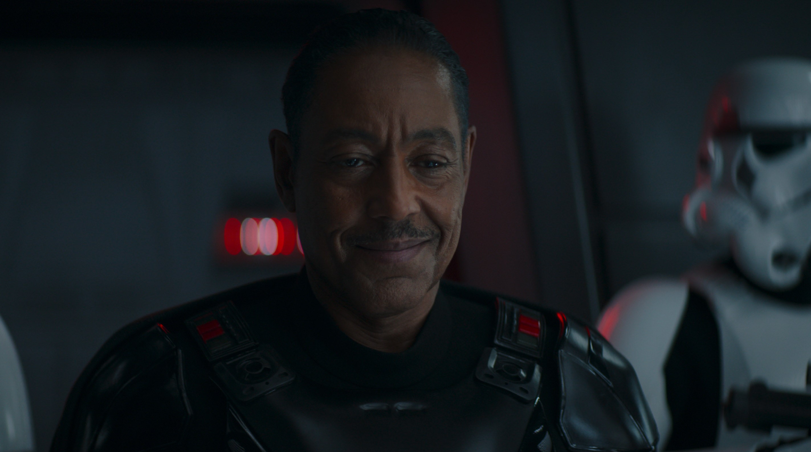 Giancarlo Esposito's Moff Gideon smiles as he looks down at Baby Yoda in The Mandalorian season 2