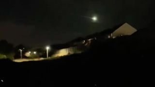 fireball flying over houses