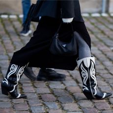 Woman walking in black and white cowboy boots