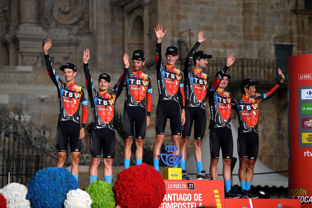 SANTIAGO DE COMPOSTELA SPAIN SEPTEMBER 05 Yukiya Arashiro of Japan Damiano Caruso of Italy Jack Haig of Australia Gino Mder of Switzerland Mark Padun of Ukraine Wouter Poels of Netherlands Jan Tratnik of Slovenia and Team Bahrain Victorious celebrates winning the best team on the podium ceremony in the Plaza del Obradoiro with the Cathedral in the background after the 76th Tour of Spain 2021 Stage 21 a 338 km Individual Time Trial stage from Padrn to Santiago de Compostela lavuelta LaVuelta21 ITT on September 05 2021 in Santiago de Compostela Spain Photo by Stuart FranklinGetty Images