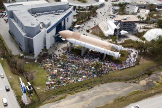 Photo of the crowds at the Kennedy Space Center Visitors' Complex to see the space shuttle Discovery's final launch.