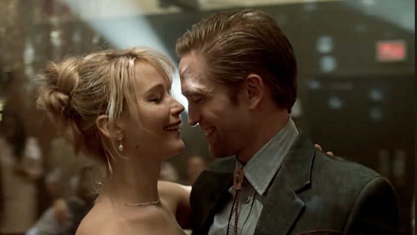 Jennifer Lawrence and Robert Pattinson, embracing one another in nice clothes as they dance in Die My Love (2025).