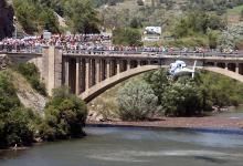 The television helicopter positions itself alongside a bridge.