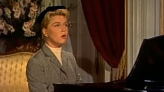 Doris Day sitting at a piano and singing in The Man Who Knew To Much