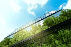 3D computer graphics image of business building with reflection trees and blue sky