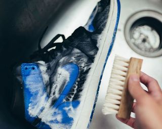 blue sneaker washed with a brush - pink miracle shoe cleaner