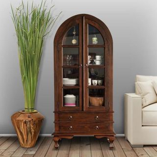 An arched wooden china cabinet from Wayfair