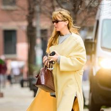 Jennifer Lawrence yellow coat and ugg boots