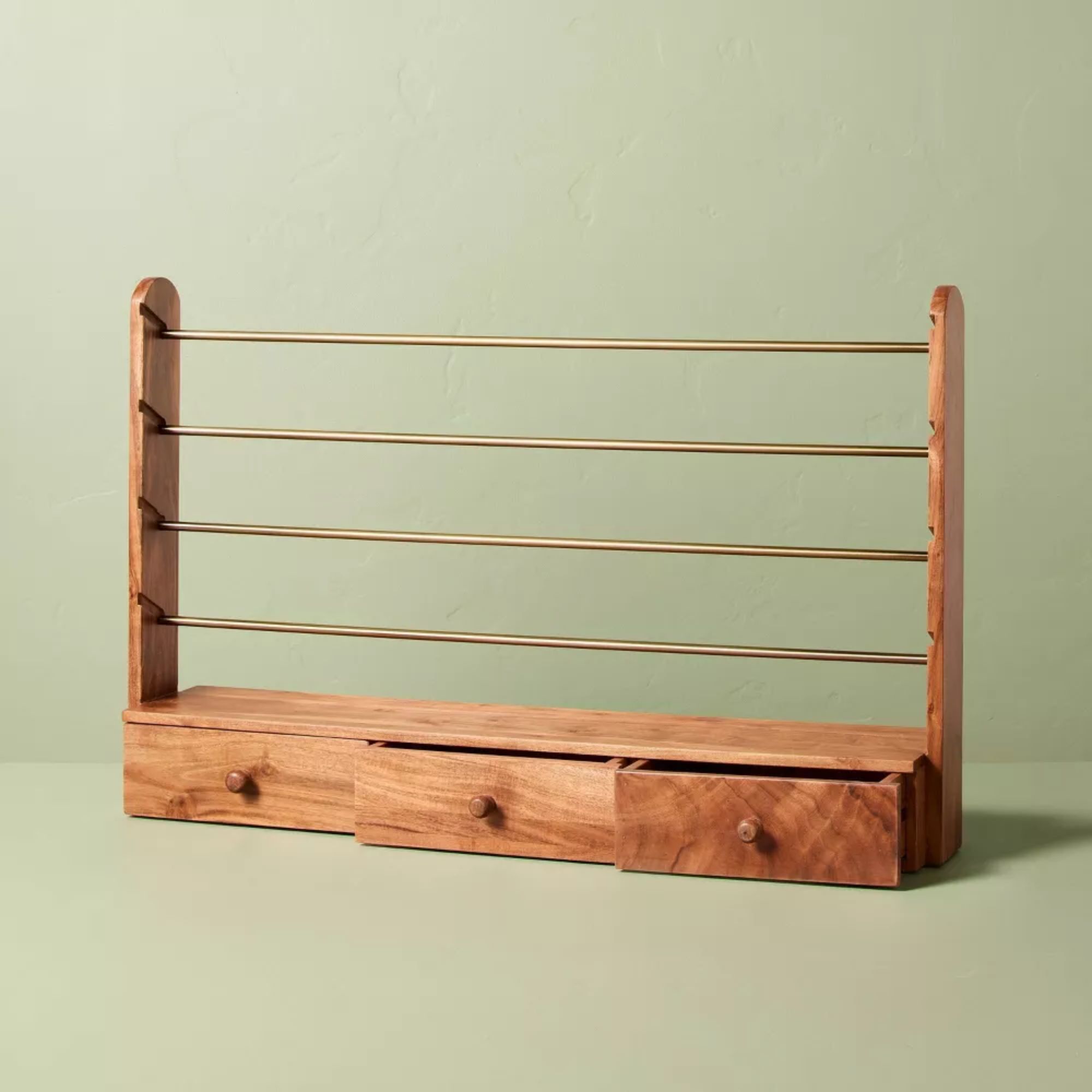 Wood gift wrap holder with three drawers and four brass rods