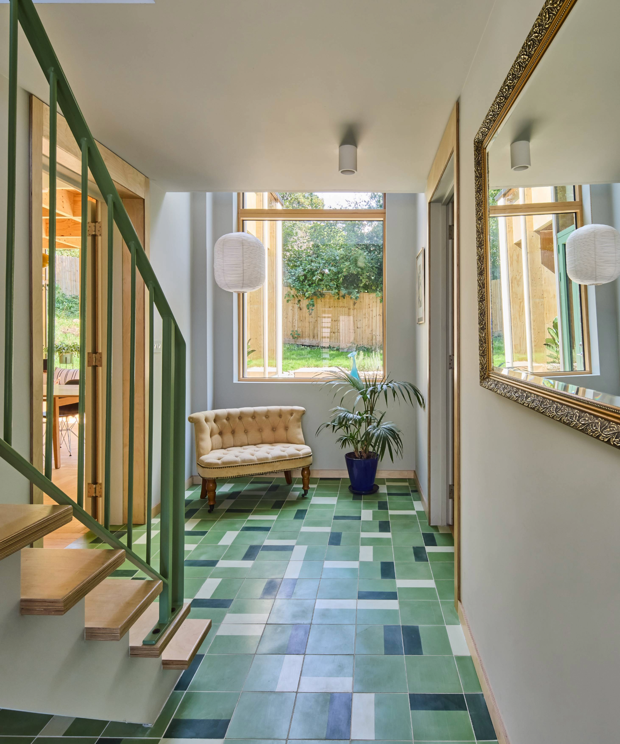 Inside the hallway with patterned green flooring and window at the end