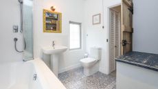 white bathroom with blue and white floor tiles