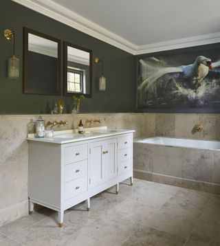An example of bathroom art ideas showing a large white double vanity below two wall mirrors and next to a swan wall mural