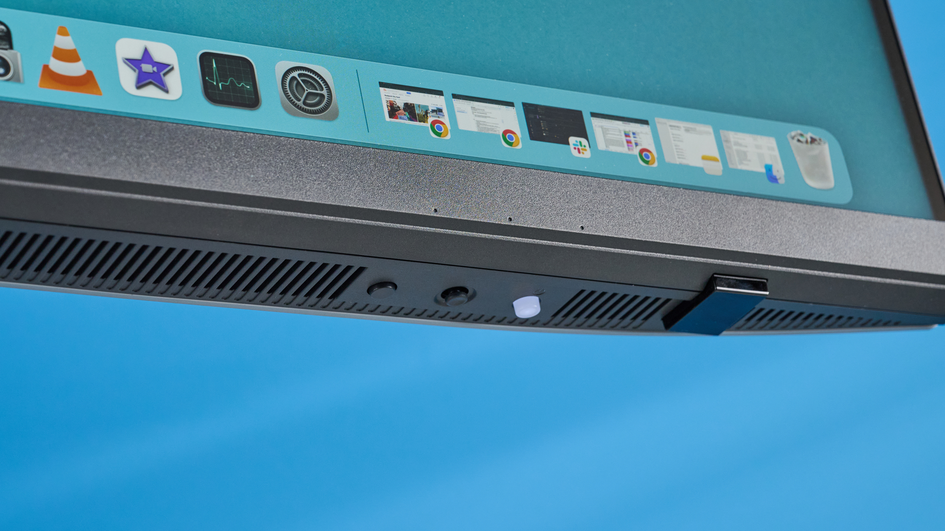 A photo of the BenQ PD3226G monitor in a blue-walled studio