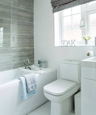 white bathroom with bathtub and towels