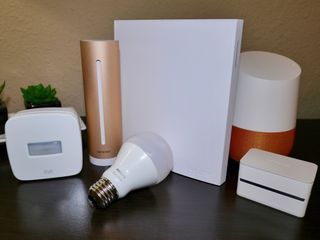 Smart home products, including a Philips Hue white bulb, an Elgato Eve motion sensor, an iDevices plug, a Wink Hub 2, a Netatmo Healthy Home Coach, and a Google Home device.