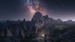 A man learning how to stargaze under a starry night sky