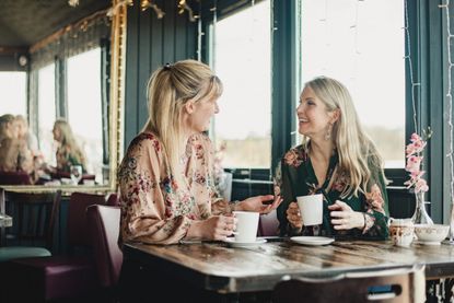 Two women chatting in a restaurant as lockdown lifts