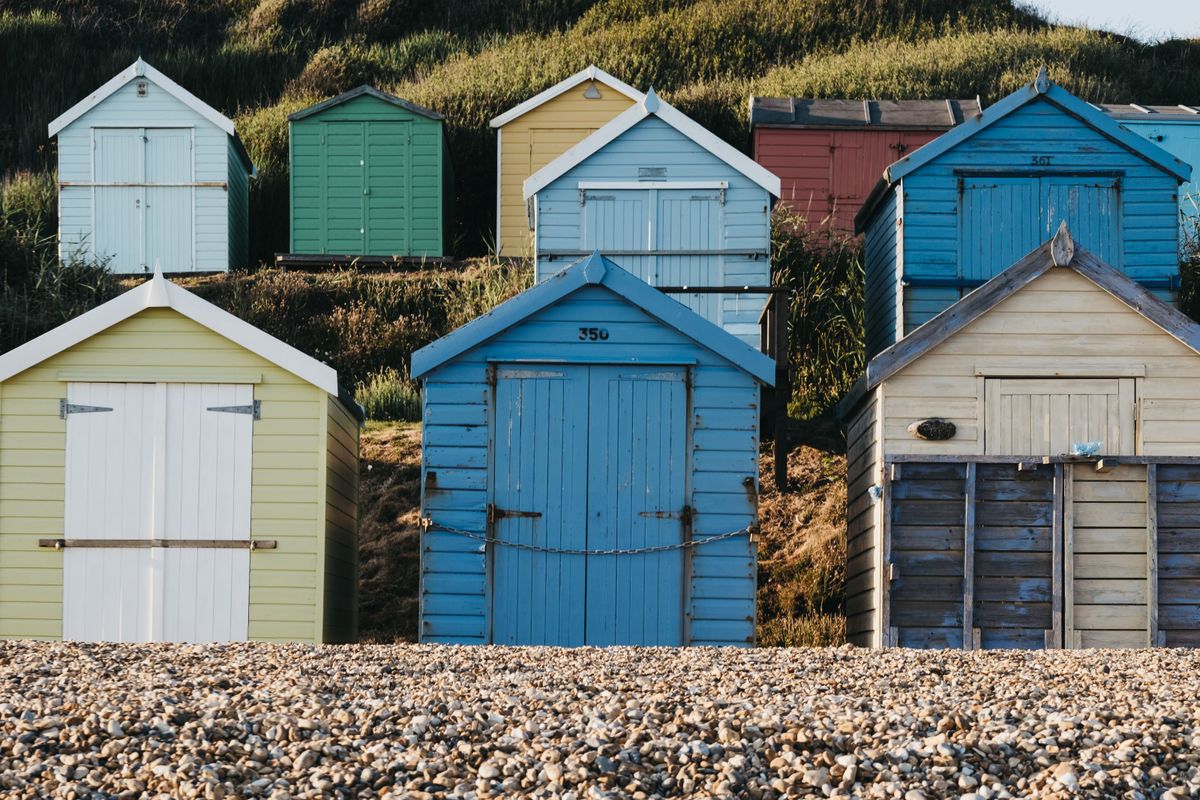 Beach huts sitting on a pebble beach in Milford-on-Sea, Lymington