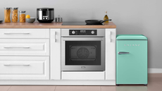 Galanz teal retro-inspired mini fridge inside of a modern kitchen