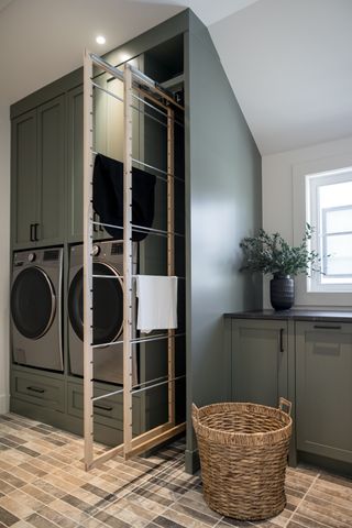 A utility room with built in cabinetry and a horizontal pull-out drying rack