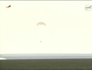 A Soyuiz TMA-04M space capsule floats toward Earth under its parachute, just moments before landing on the steppes of Kazakhstan to return Expedition 32 crewmembers Gennady Padalka, Sergei Revin (both of Russia) and NASA astronaut Joe Acaba to Earth on Se