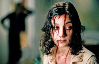Lina Leandersson in Let The Right One In, one of the best horror movies that are 95% and up on Rotten Tomatoes