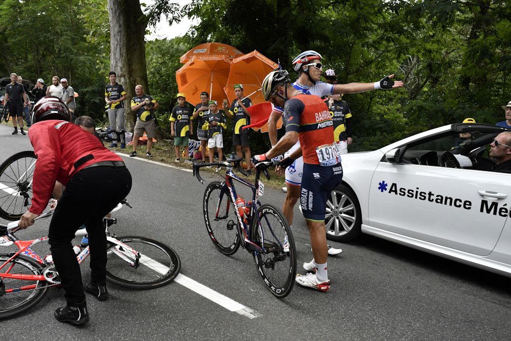 Yukiya Arashiro and Sonny Colbrelli get up after a crash during stage 11 at the Tour de France