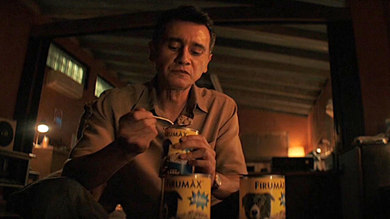 Manousos (Carlos-Manuel Vesga) eats from a can of dog food on Pluribus.
