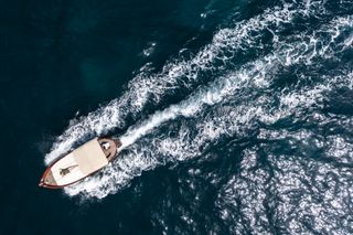 Aerial shot of a boat speeding through the water