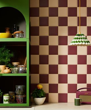 A cream and burgundy kitchen backsplash