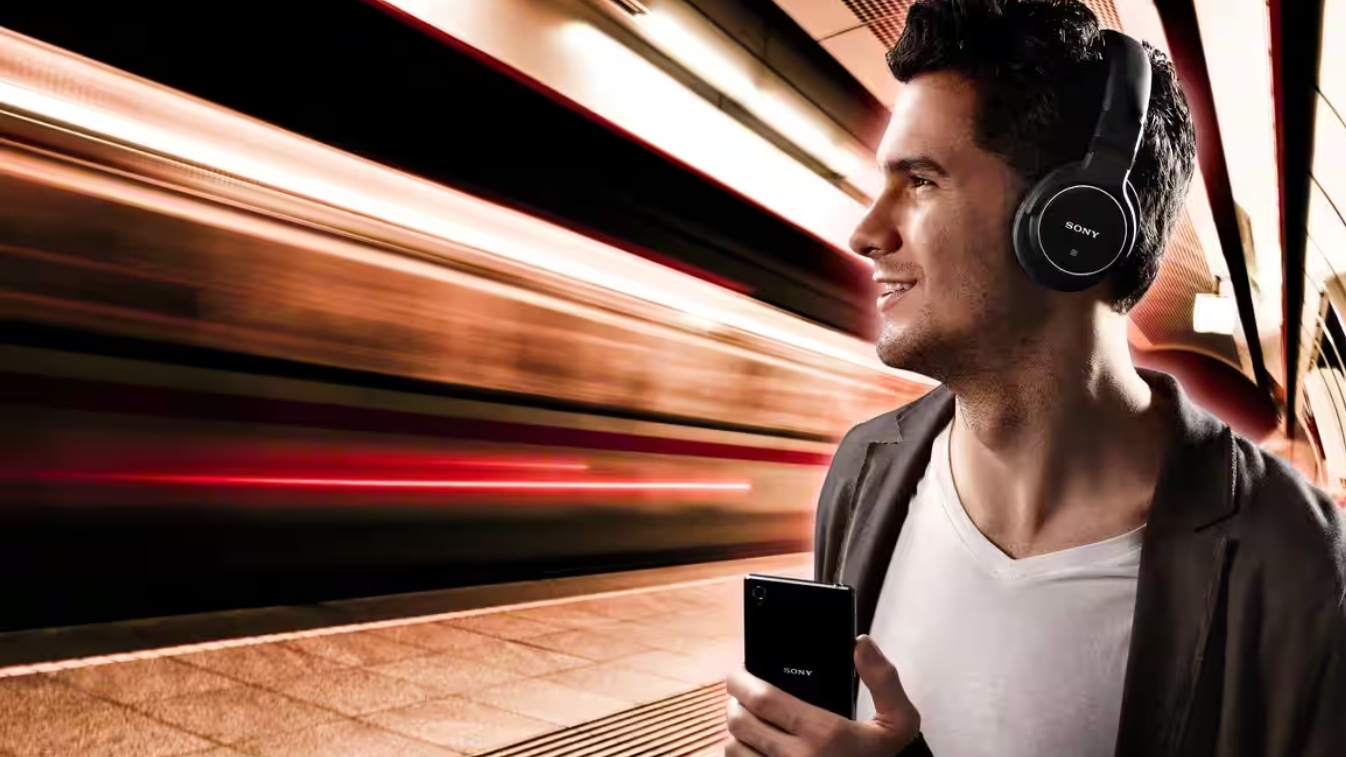 Sony MDR-1AM2 Headphones worn by a man in a subway station