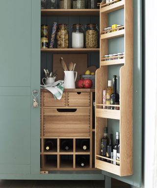 pantry with green cupboard and glass jars