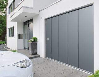 Grey sectional garage door on a modern home by Hormann UK