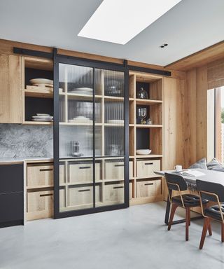 Modern kitchen with glass and wood storage cabinet for pots