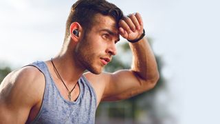 Creative Outlier headphones worn by man exercising