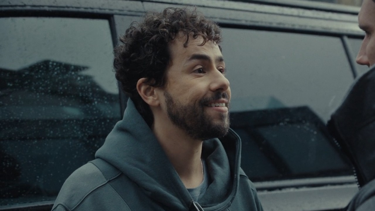 Ramy Youssef smiling in Mountainhead.