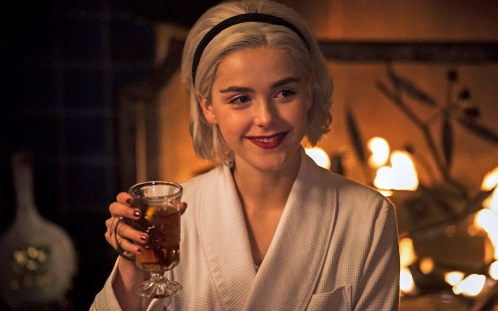 Kiernan Shipka (as Sabrina) raises a glass in Chilling Adventures of Sabrina