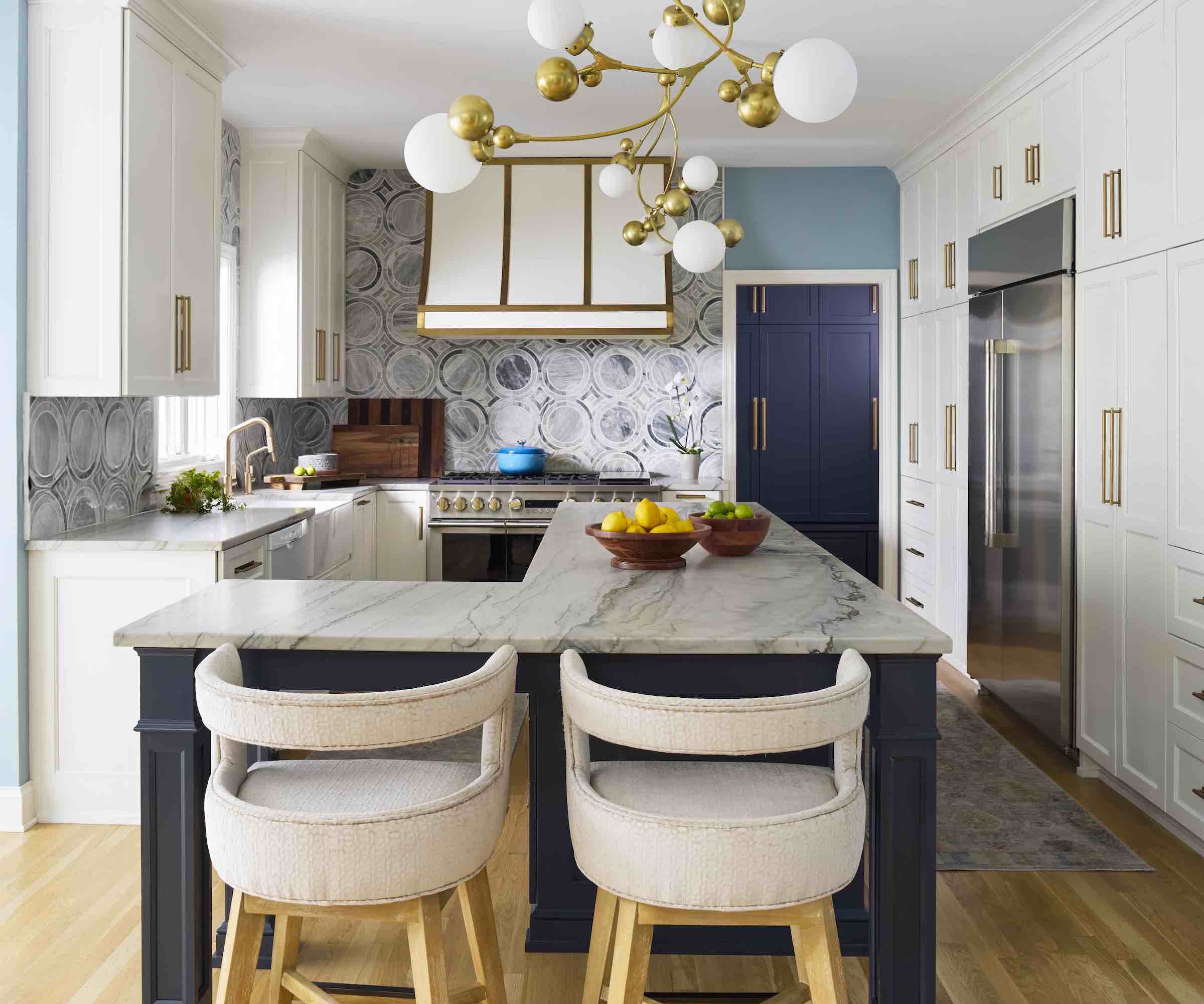 L-shape kitchen island with two bar stools and marble tops
