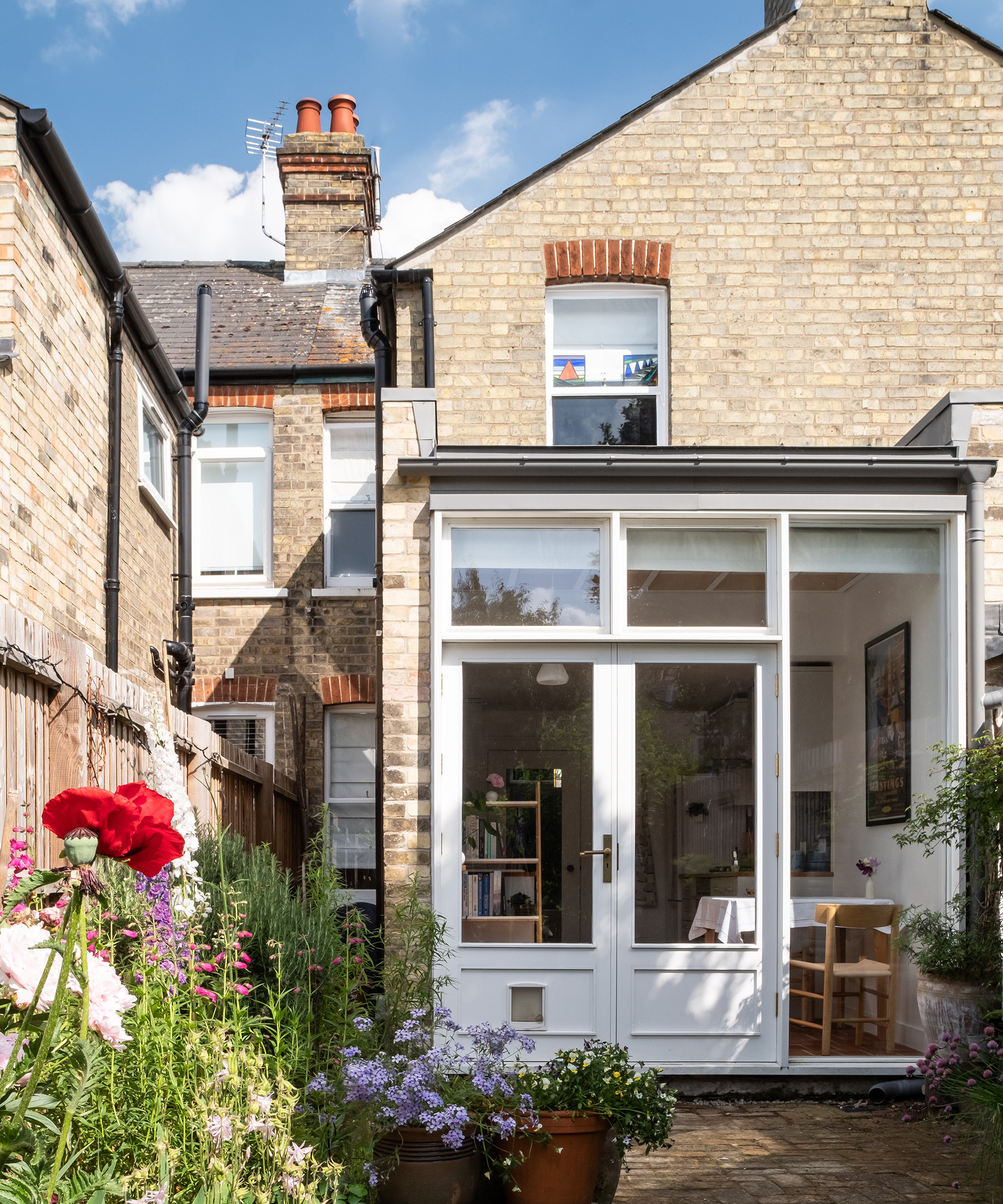 The rear extension of a Victorian terraced house with white framed french doors
