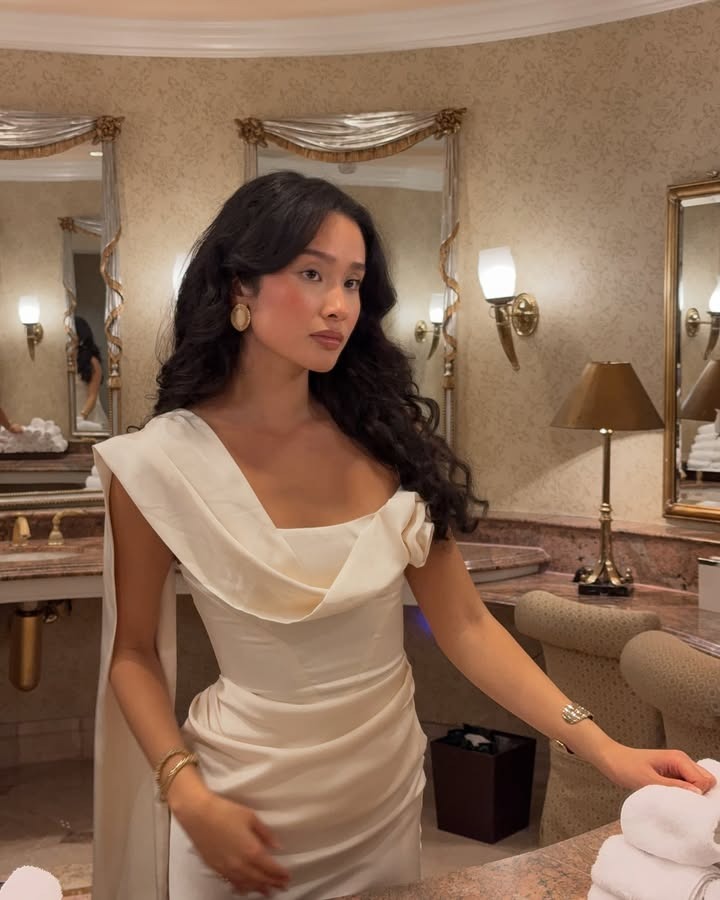 A woman with long, curled hair.