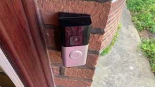 Ring Battery Video Doorbell Plus mounted on a brick wall