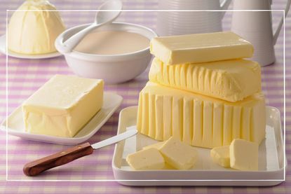 various blocks of butter in different shapes presented on butter dishes on a table with a pretty gingham table cloth