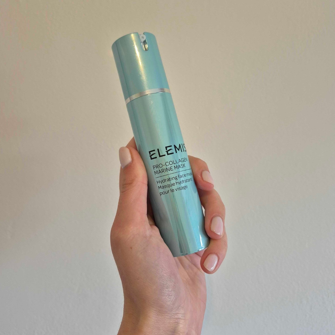 A close-up of Digital Beauty Writer, Naomi Jamieson holding up the Elemis Pro-Collagen Marine Mask, in front of a cream wall